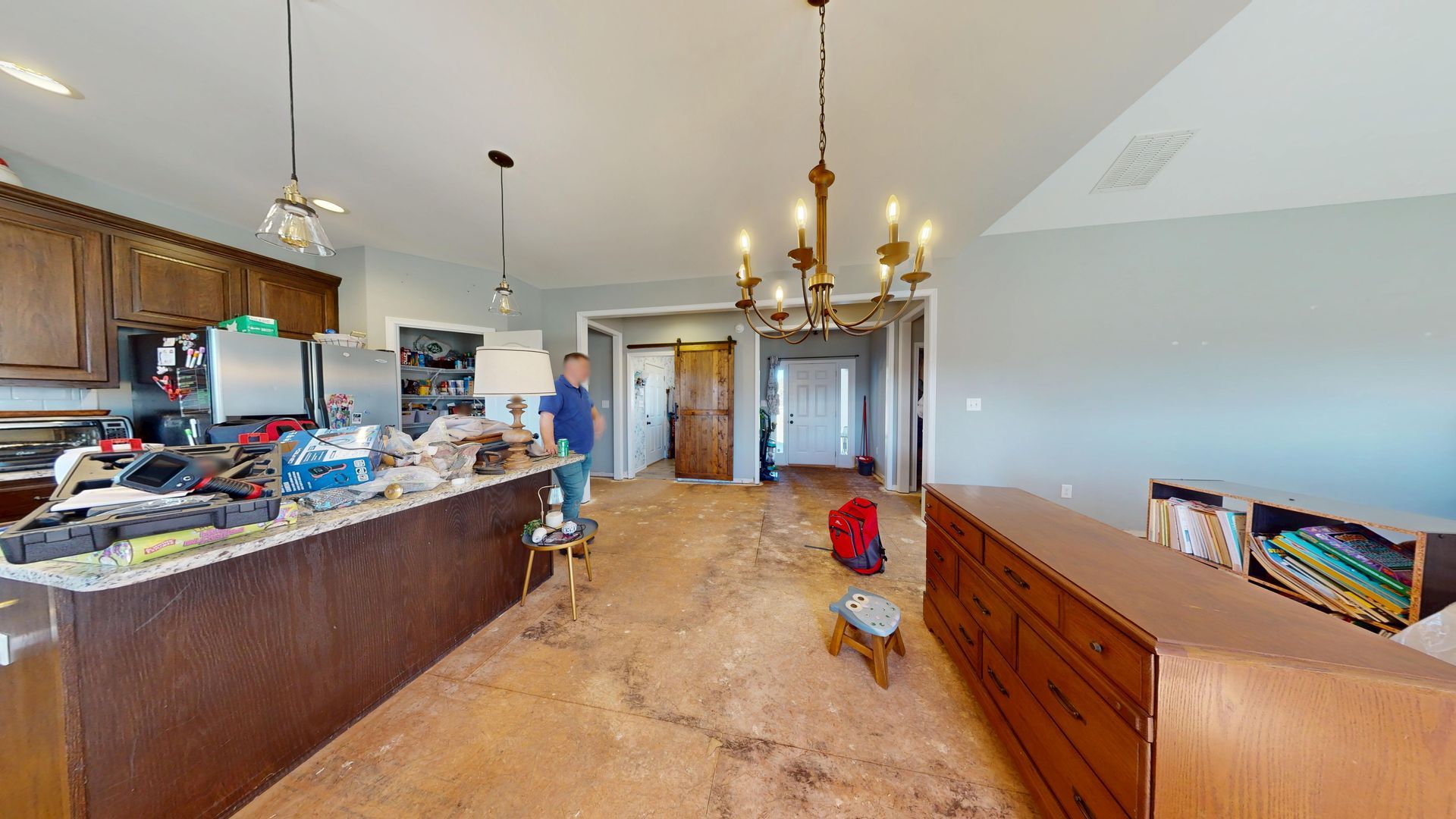 Kitchen and dining room before restoration with water-damaged flooring