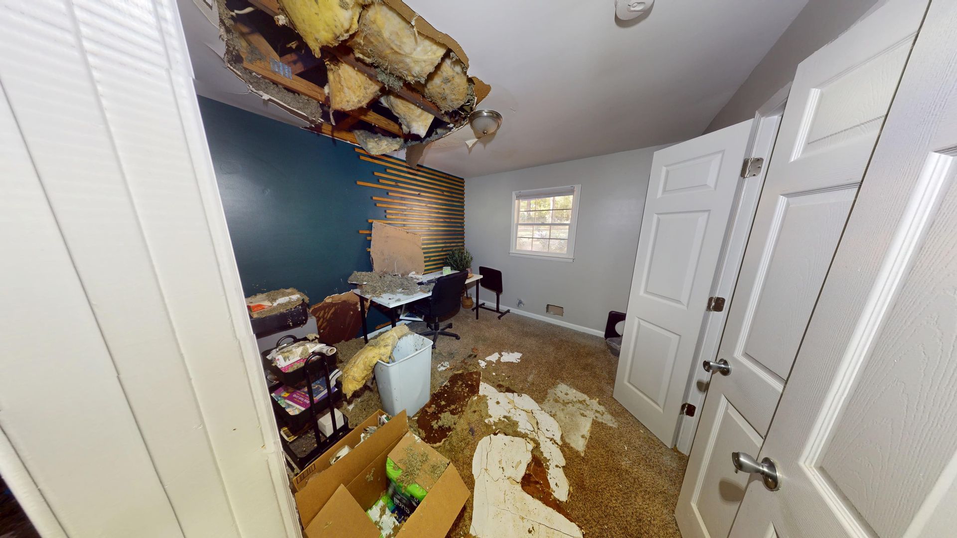 Bedroom with water stained ceiling and walls before repair in Stone Mountain