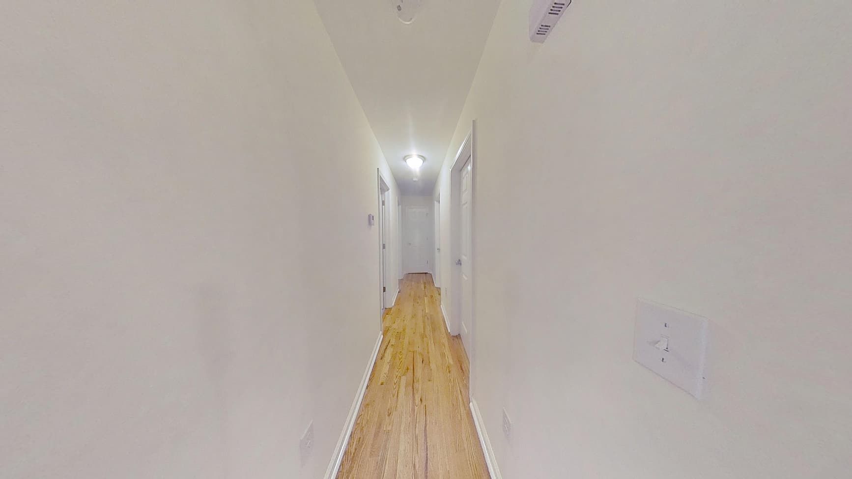 Clean restored hallway with fresh walls and flooring after water cleanup