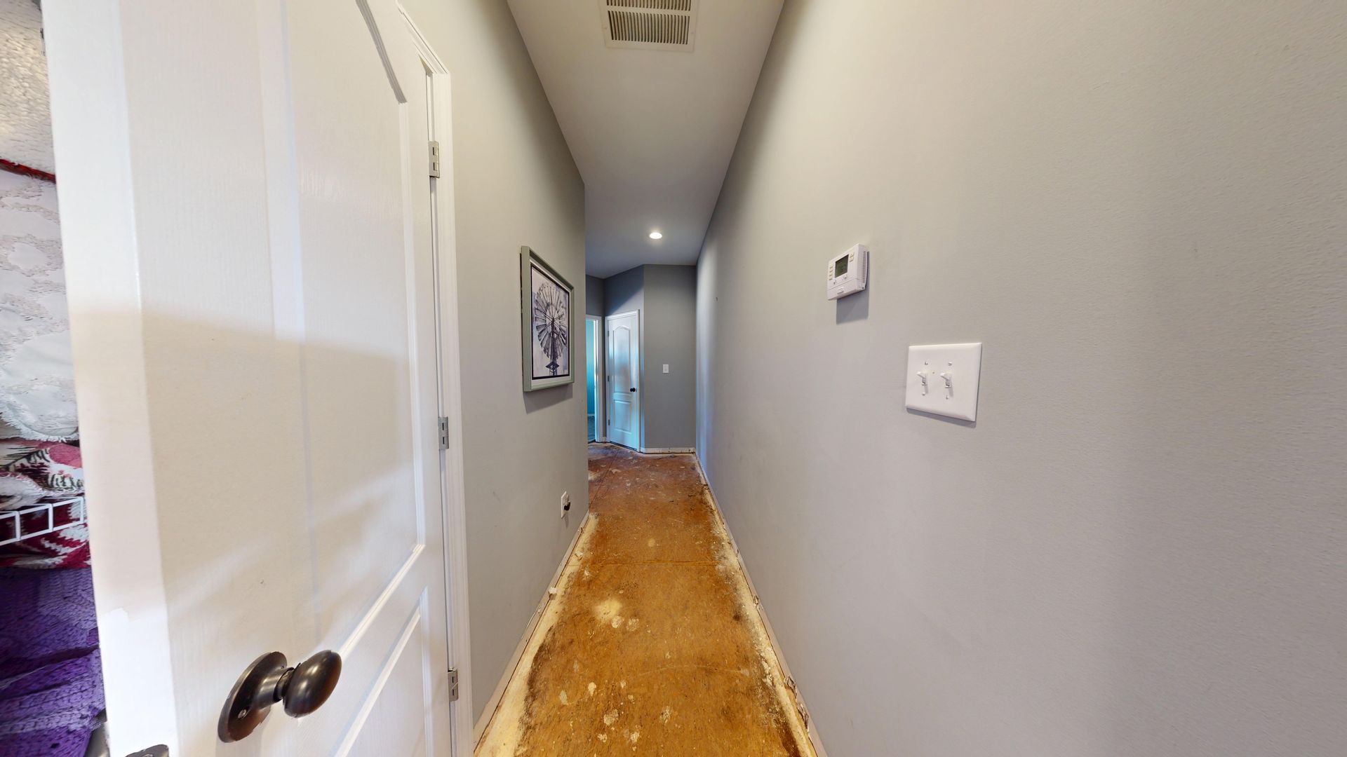 Hallway before water damage restoration with saturated flooring