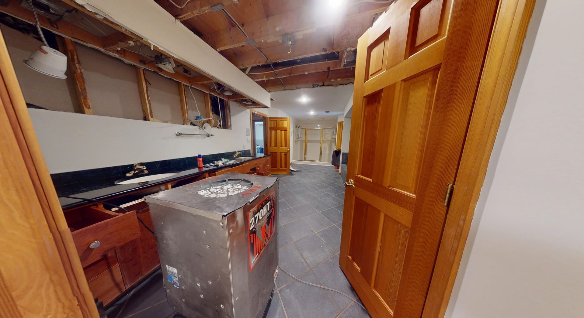 Bathroom ceiling water damage from upper floor flood before restoration in Atlanta home