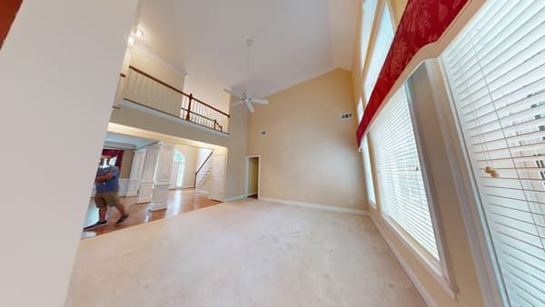 Entryway and family room with water damaged flooring before restoration
