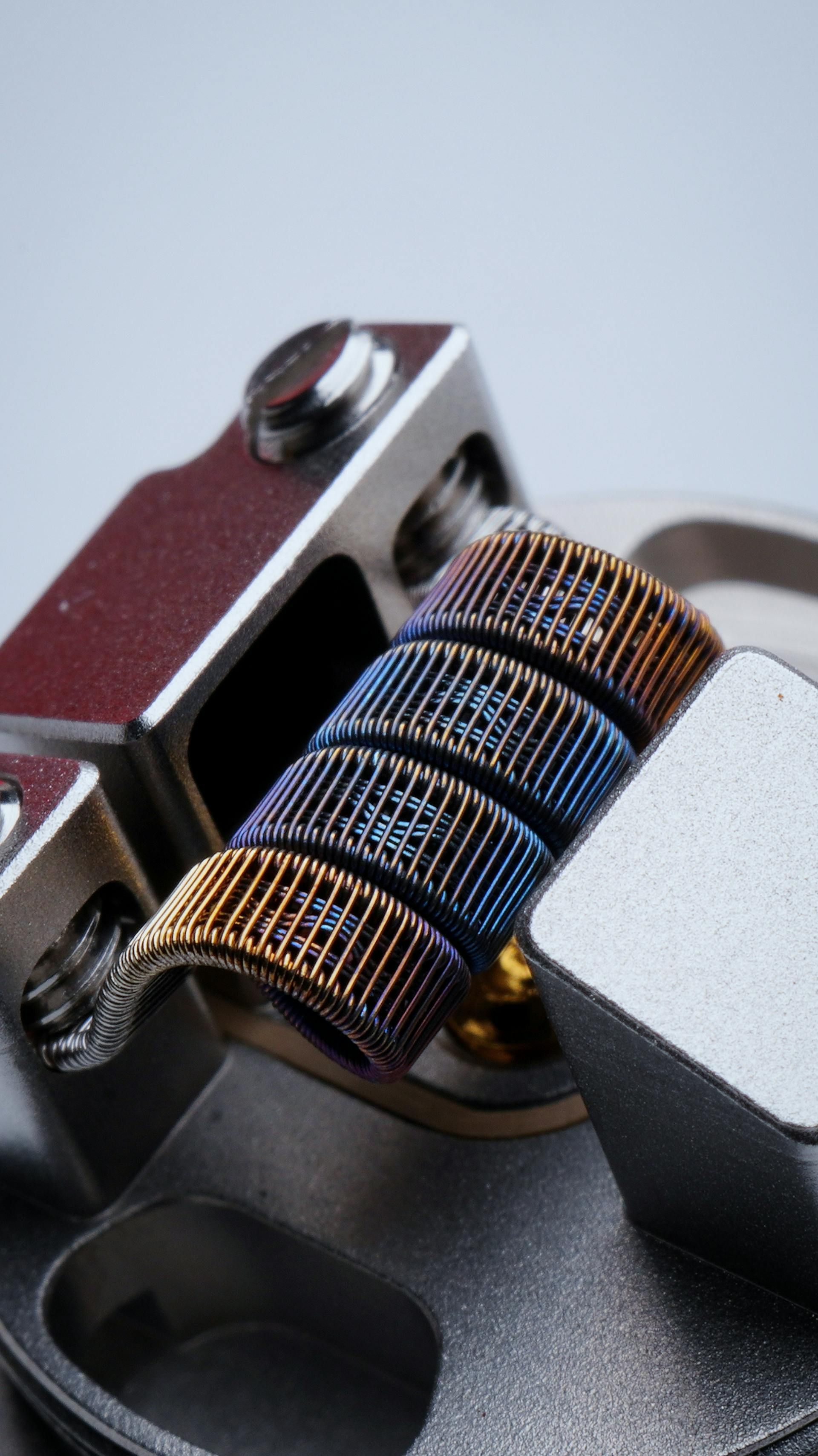 A close up of a coil sitting on top of a metal device.