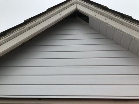 White soffits, siding with an open vent.