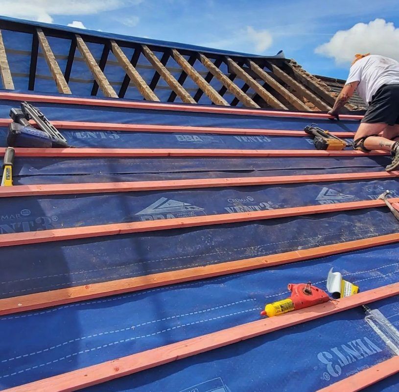 Roofer repairing a roof framework on a residential property in Cambridgeshire.