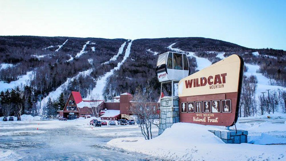 wildcat ski resort on it in front of a snowy mountain