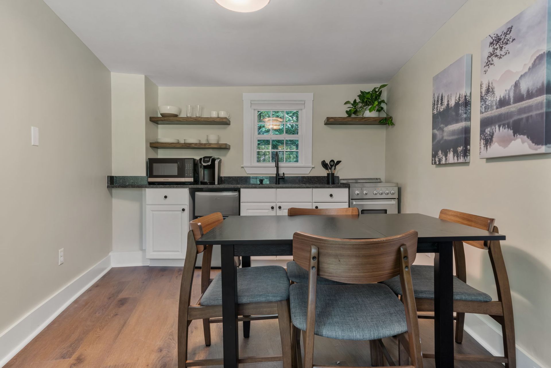 A kitchen with a table and chairs in it