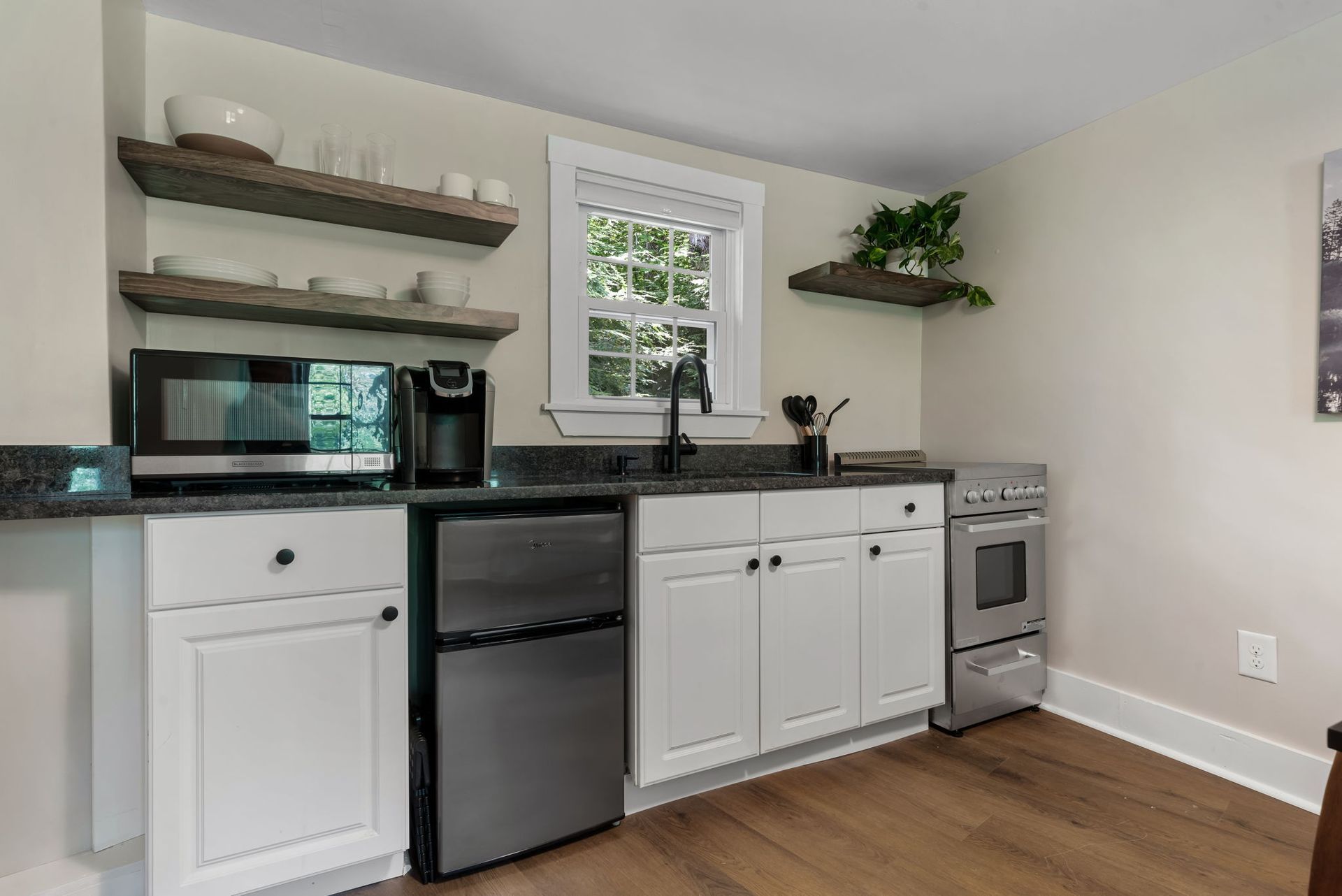 A kitchen with white cabinets and stainless steel appliances.
