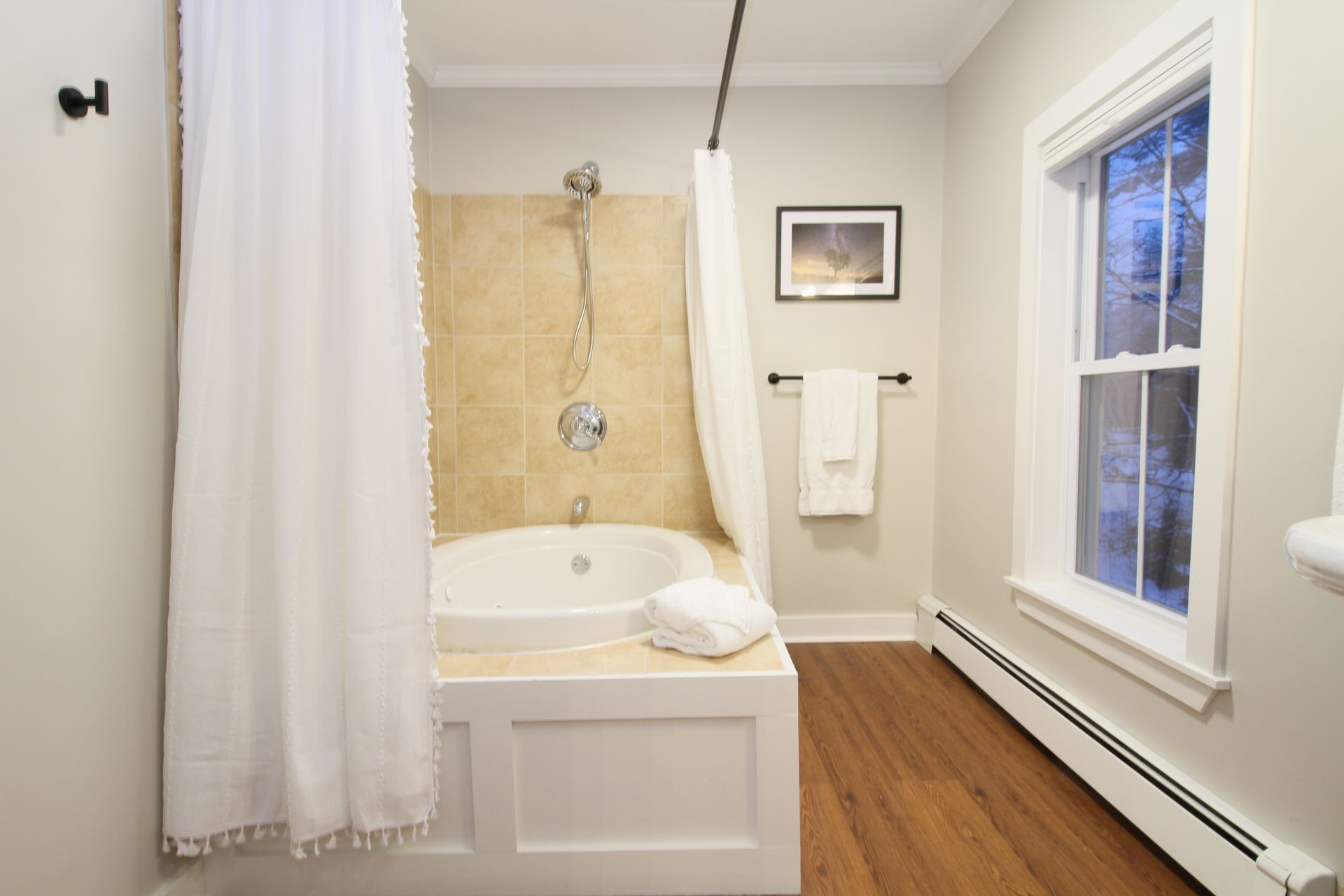 A bathroom with a jacuzzi tub and a window