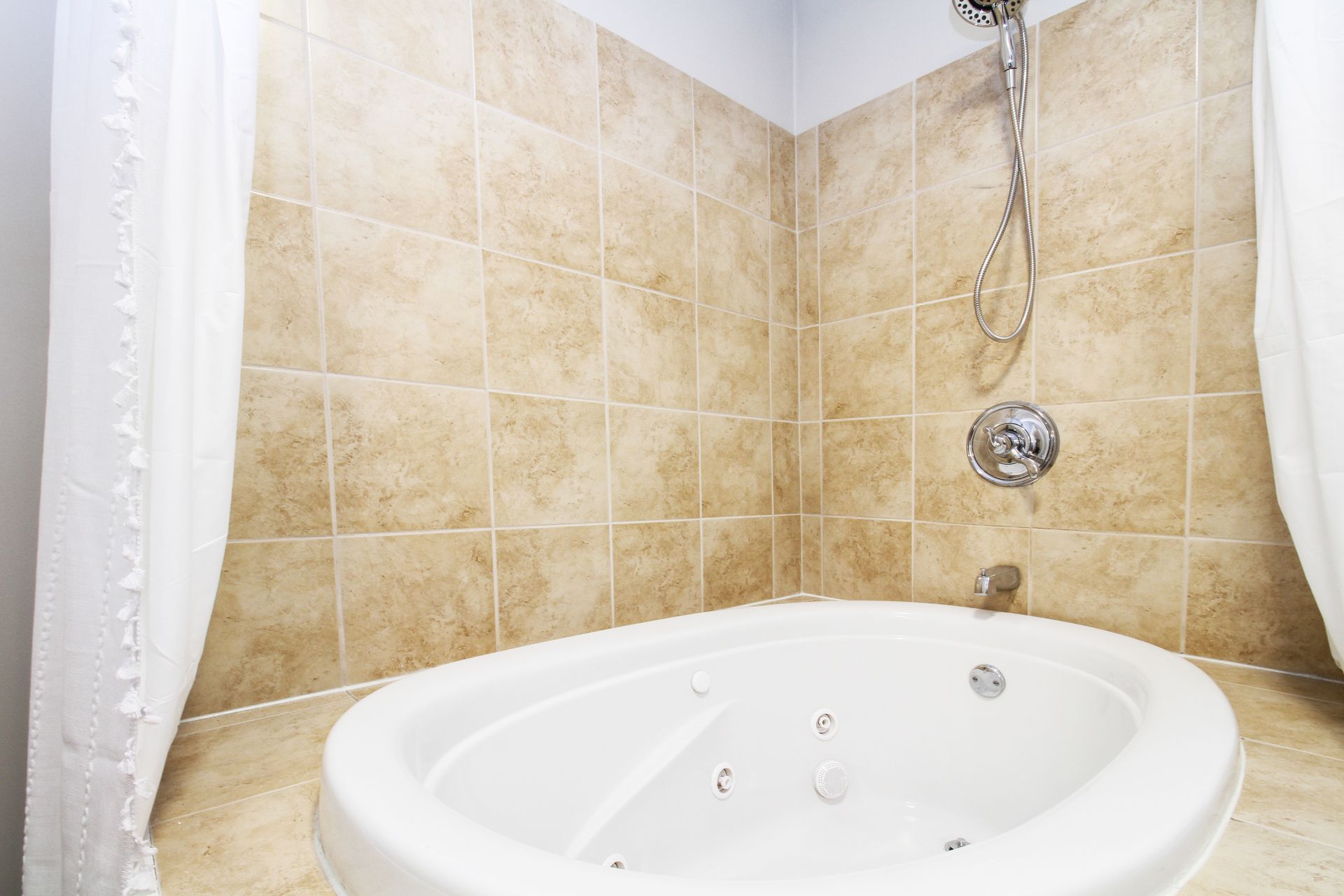 A bathroom with a jacuzzi tub and a shower.