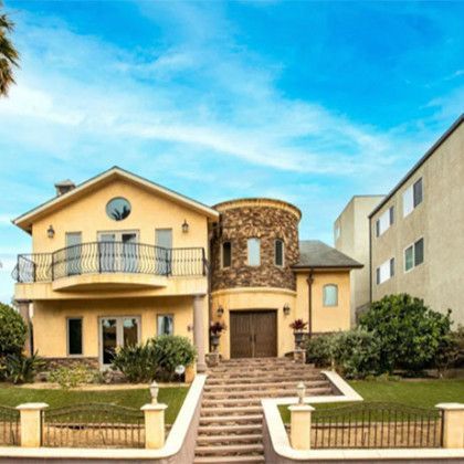 A large house with stairs leading up to it