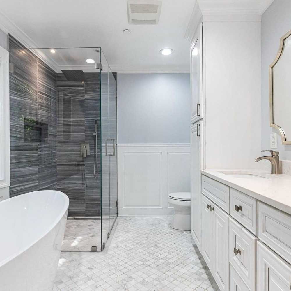 A bathroom with a tub , sink , toilet and shower.