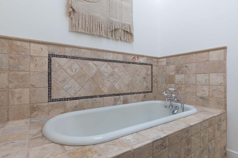 There is a bathtub in the middle of the bathroom.