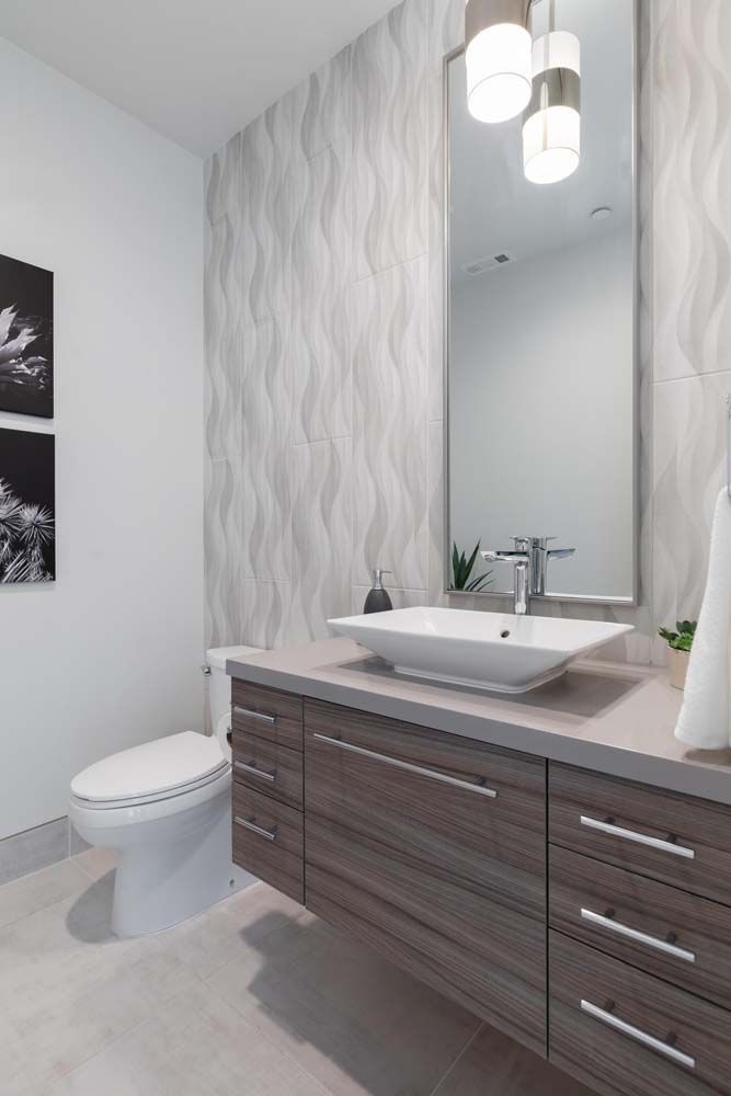 A bathroom with a sink , toilet and mirror.