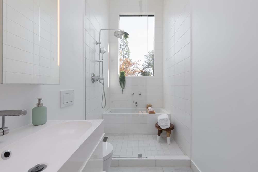 A bathroom with a tub , sink , toilet and shower.