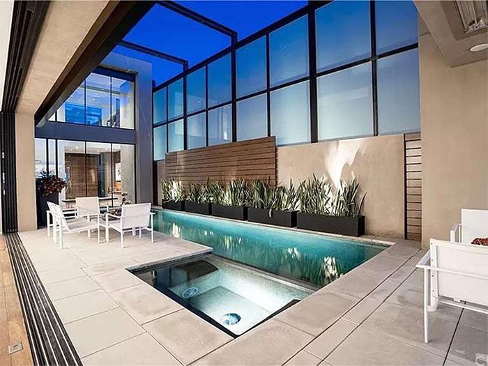 There is a large swimming pool in the middle of the house.