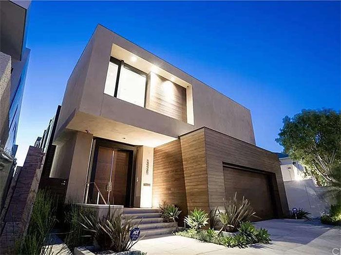 A modern house with a lot of windows and a garage