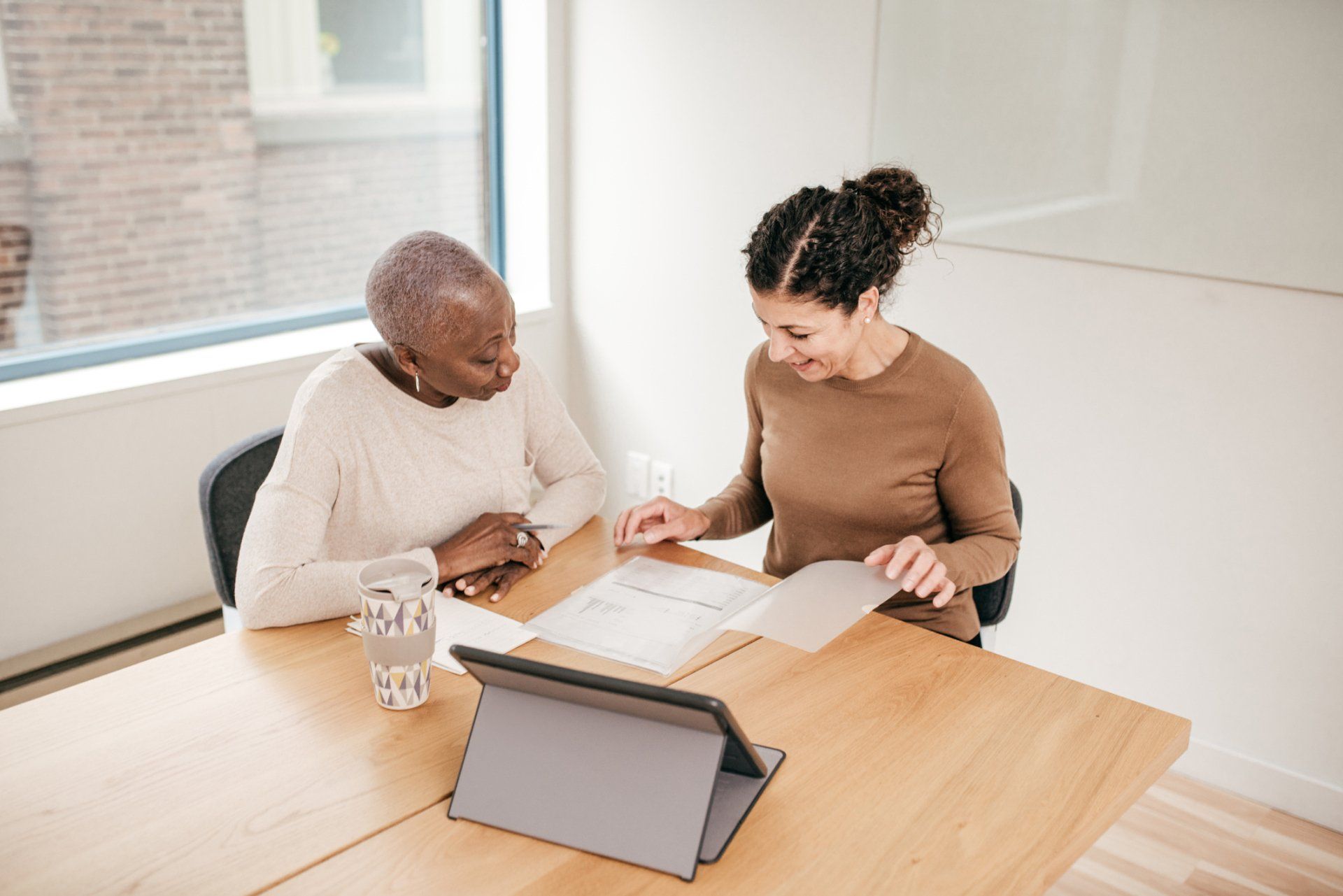 Woman And Senior Reading — St. Joseph, MI — Bittner & Jennings Attorneys Woman And Senior Reading — St. Joseph, MI — Bittner & Jennings Attorneys