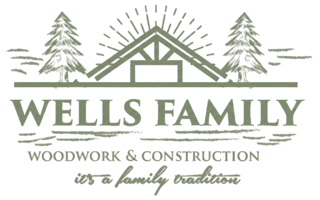 Logo for Wells Family Woodwork & Construction featuring a house frame, pine trees, and text.