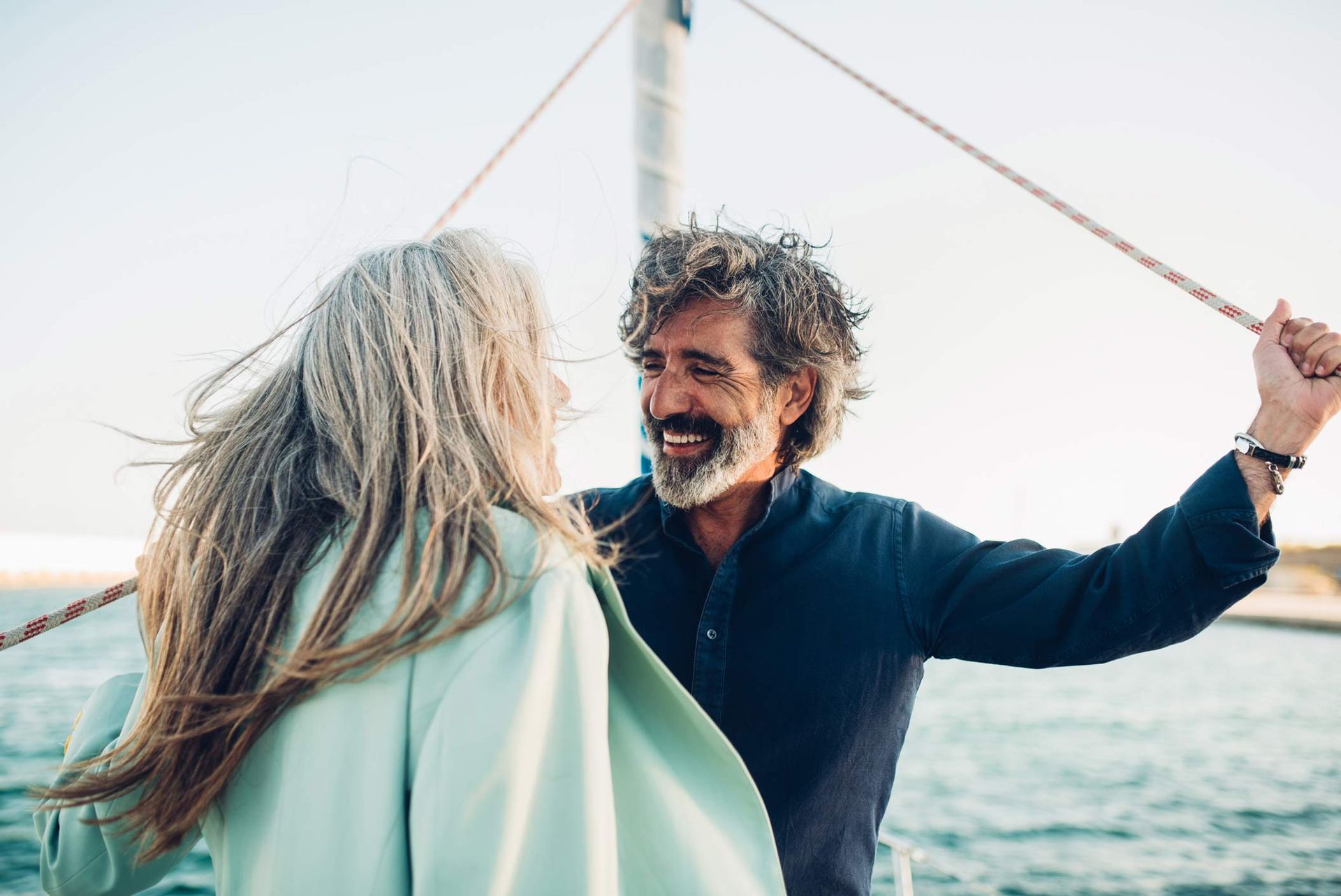 Mature Couple enjoying sailing with their yacht. Mature Couple enjoying sailing with their yacht.