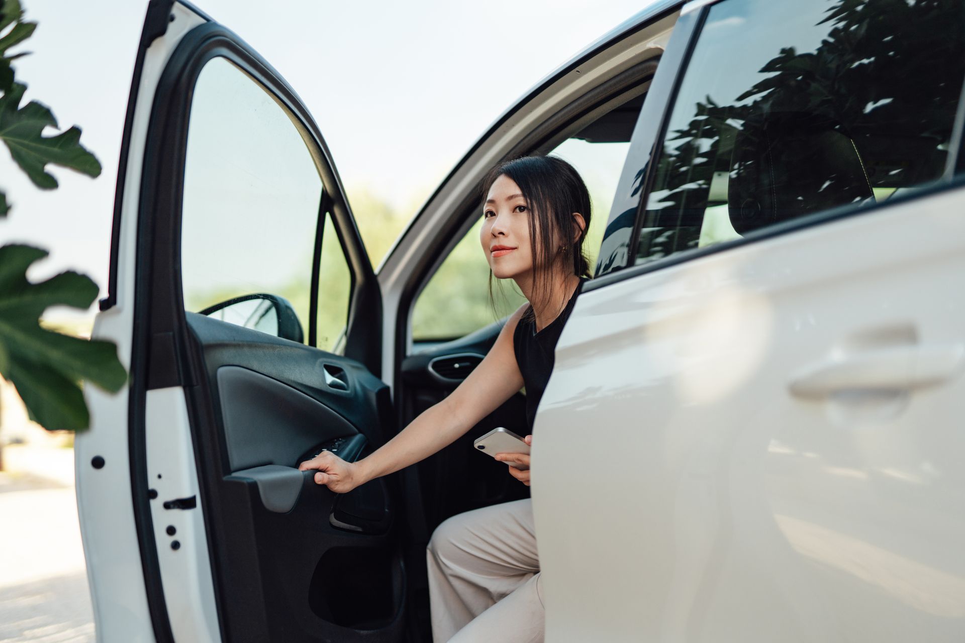 Businesswoman leaving a car upon arrival, highlighting reliable business auto insurance. Businesswoman leaving a car upon arrival, highlighting reliable business auto insurance.