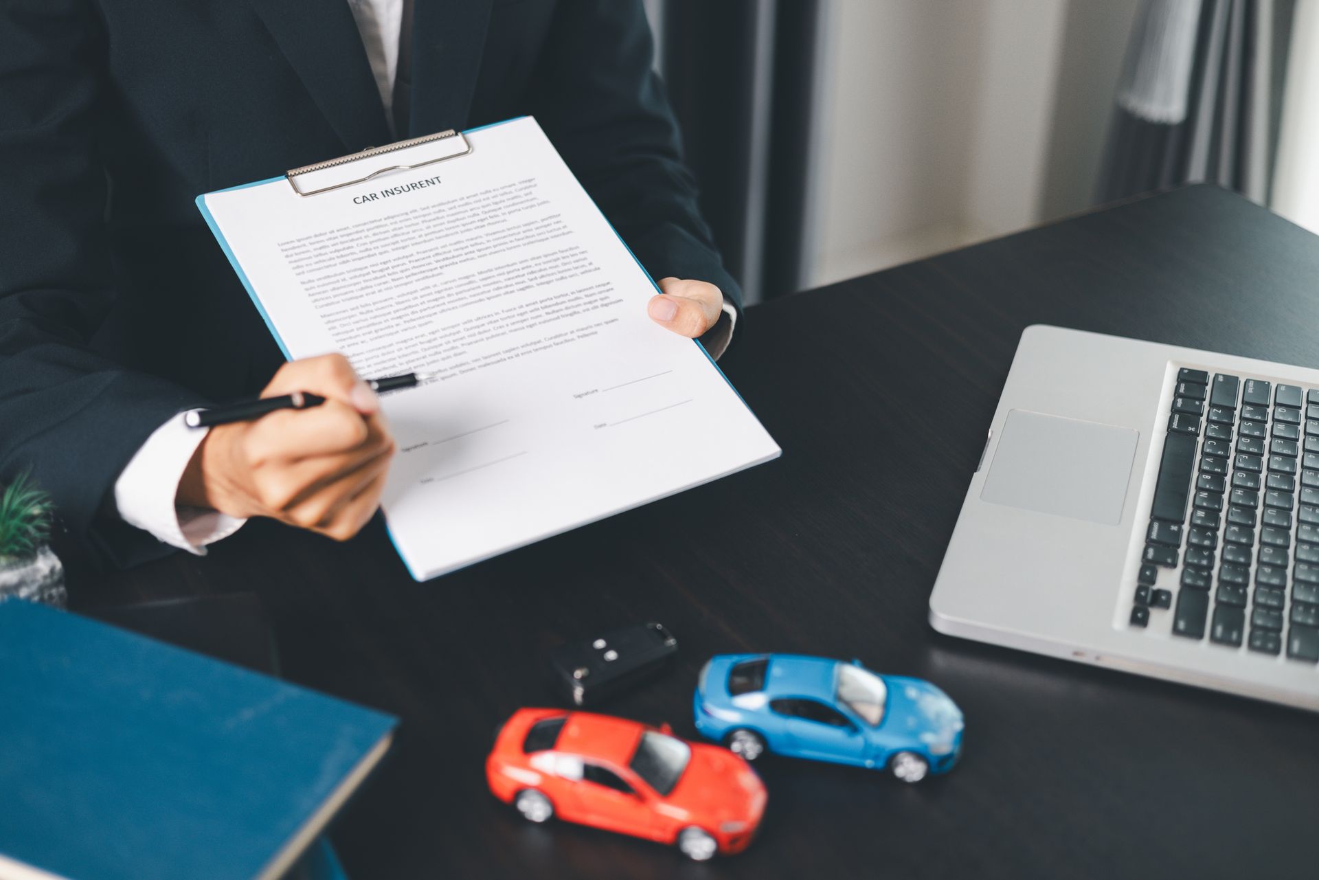 An insurance agent reviewing car insurance coverage with a client.