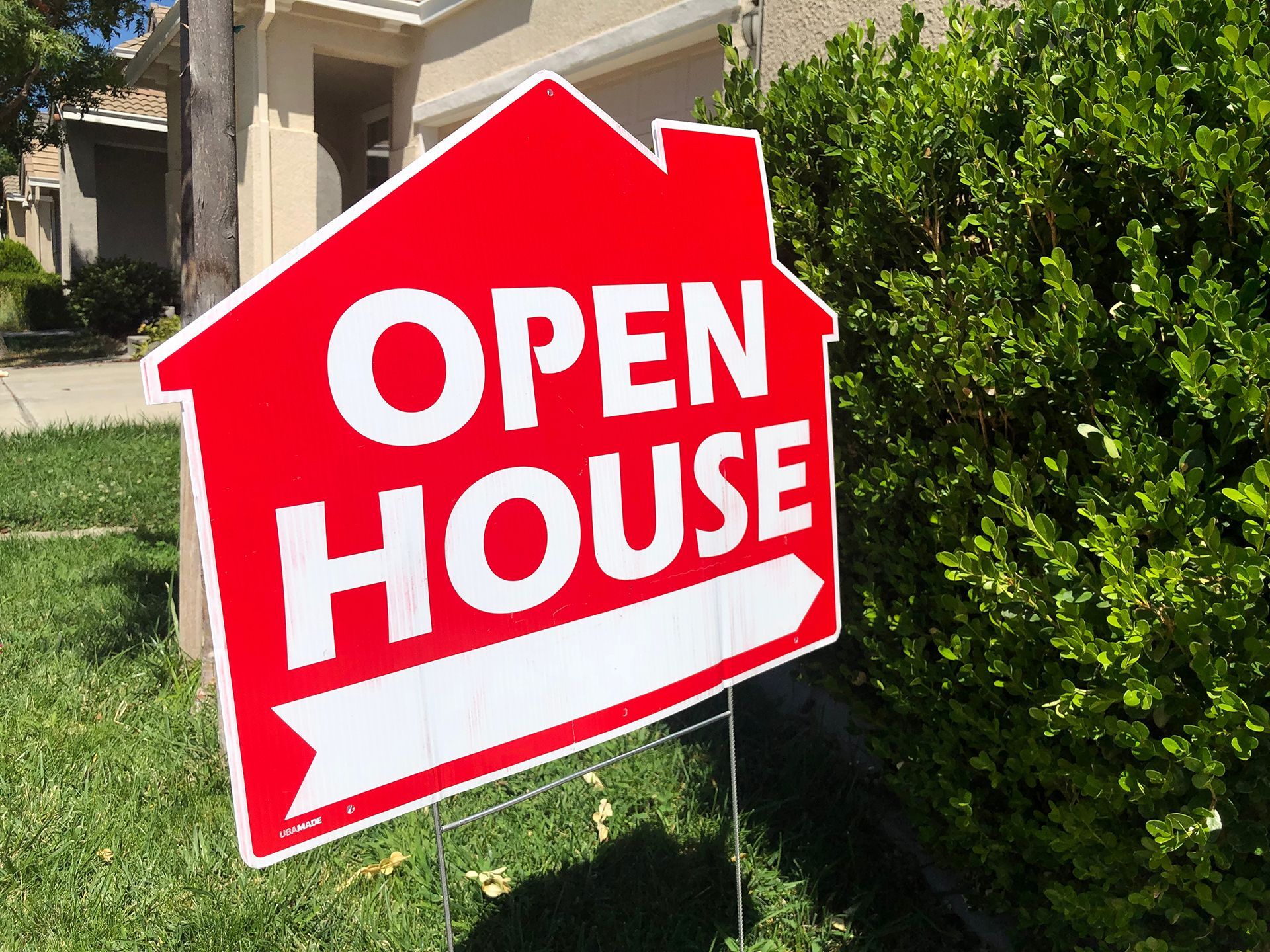 An open house sign in front of a house