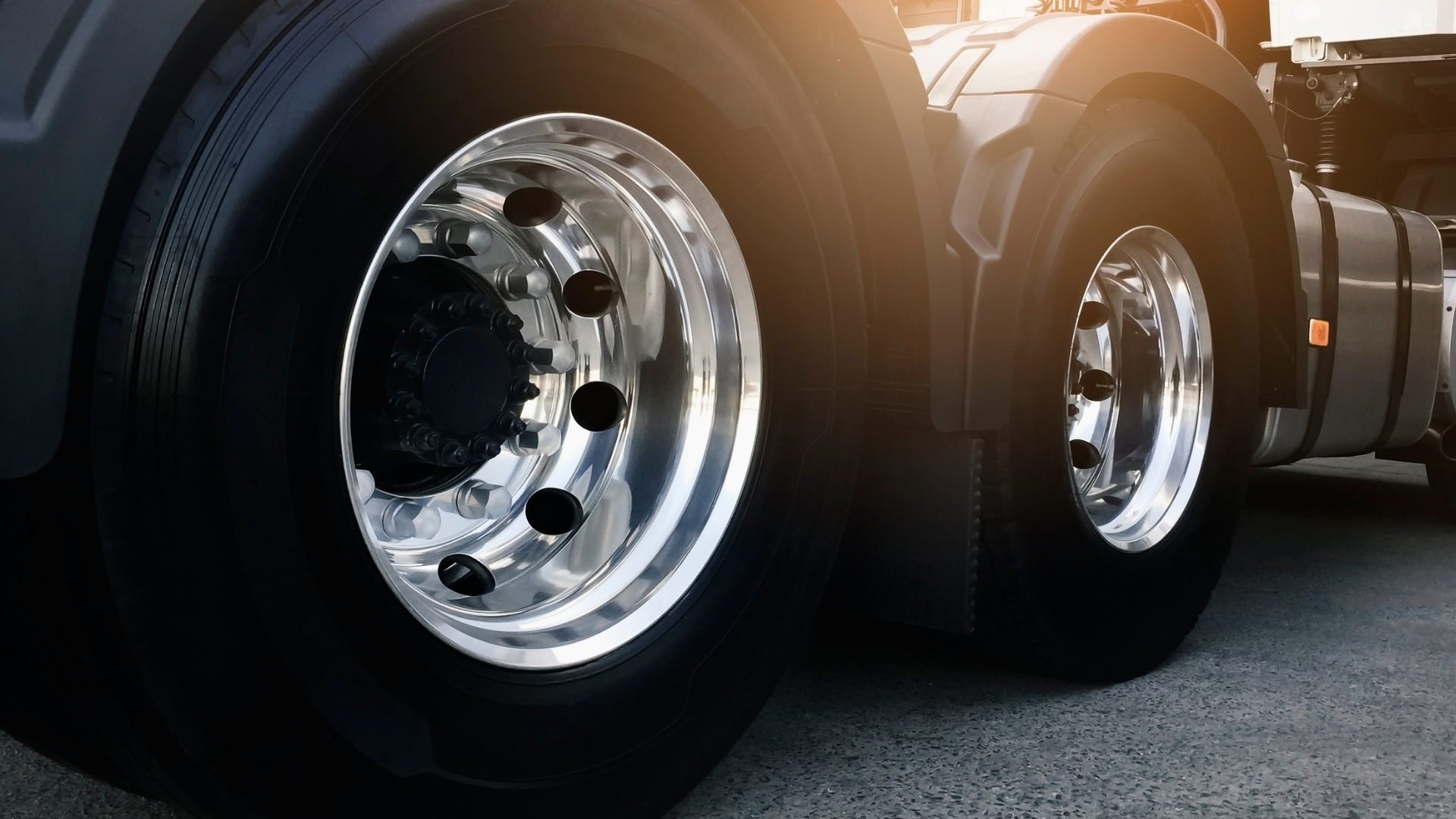 A close up of a semi truck 's wheels and tires.