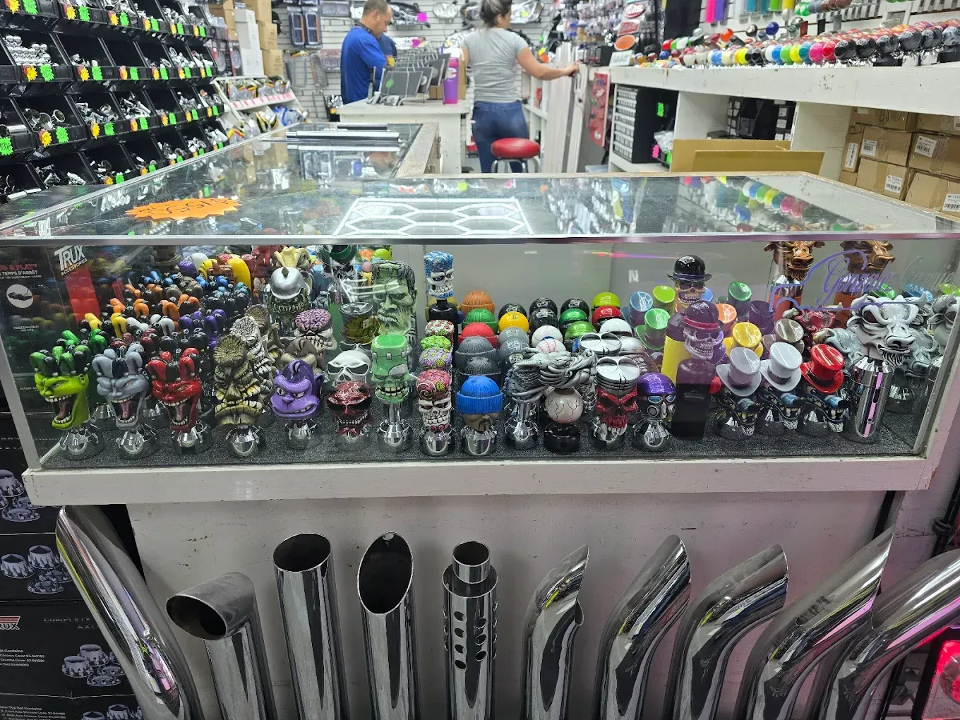 A woman is standing behind a counter in a store.