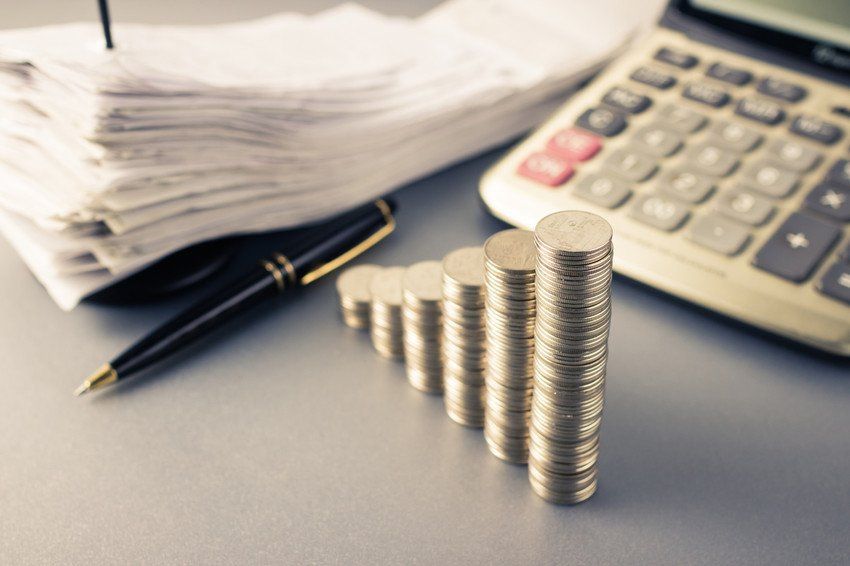 Coins heap stair as growing graph symbol on finance working desk