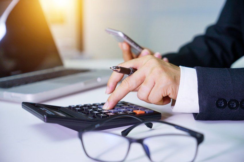 Close up of male accountant or banker making calculations