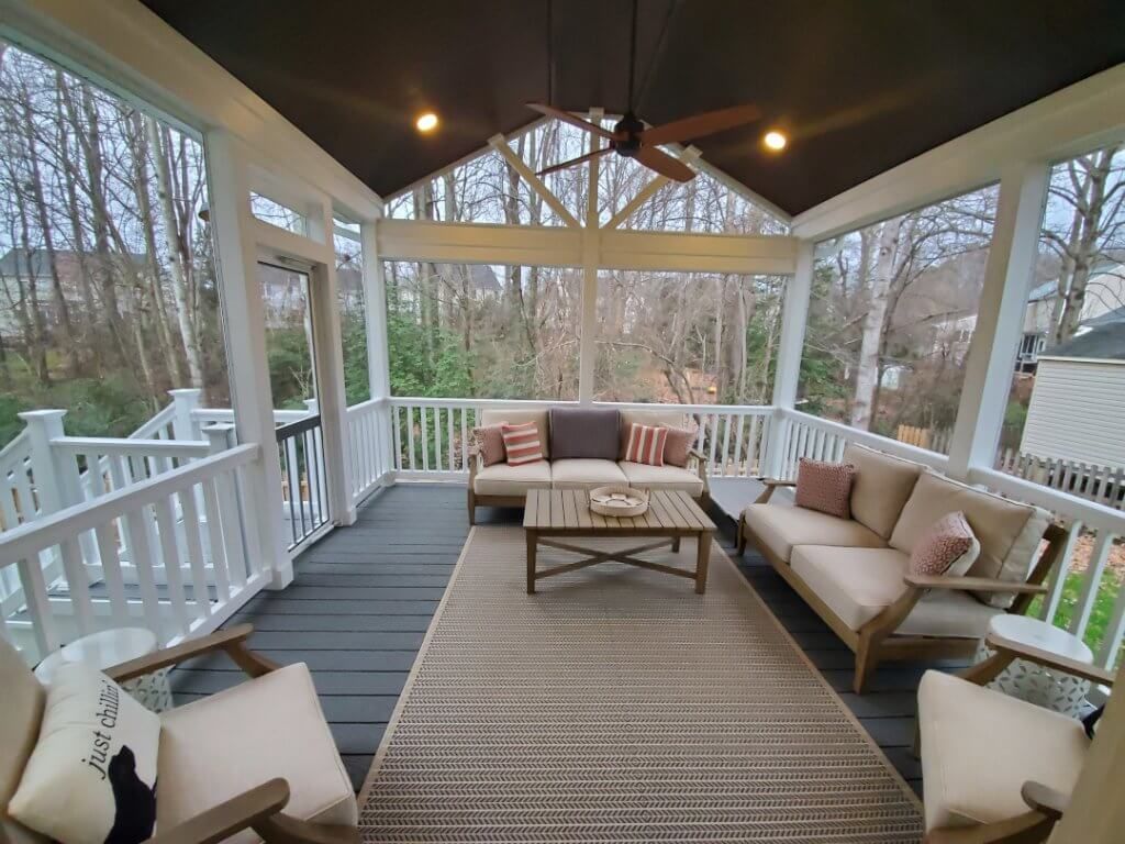 Home Additions: A screened-in porch with furniture and a ceiling fan.