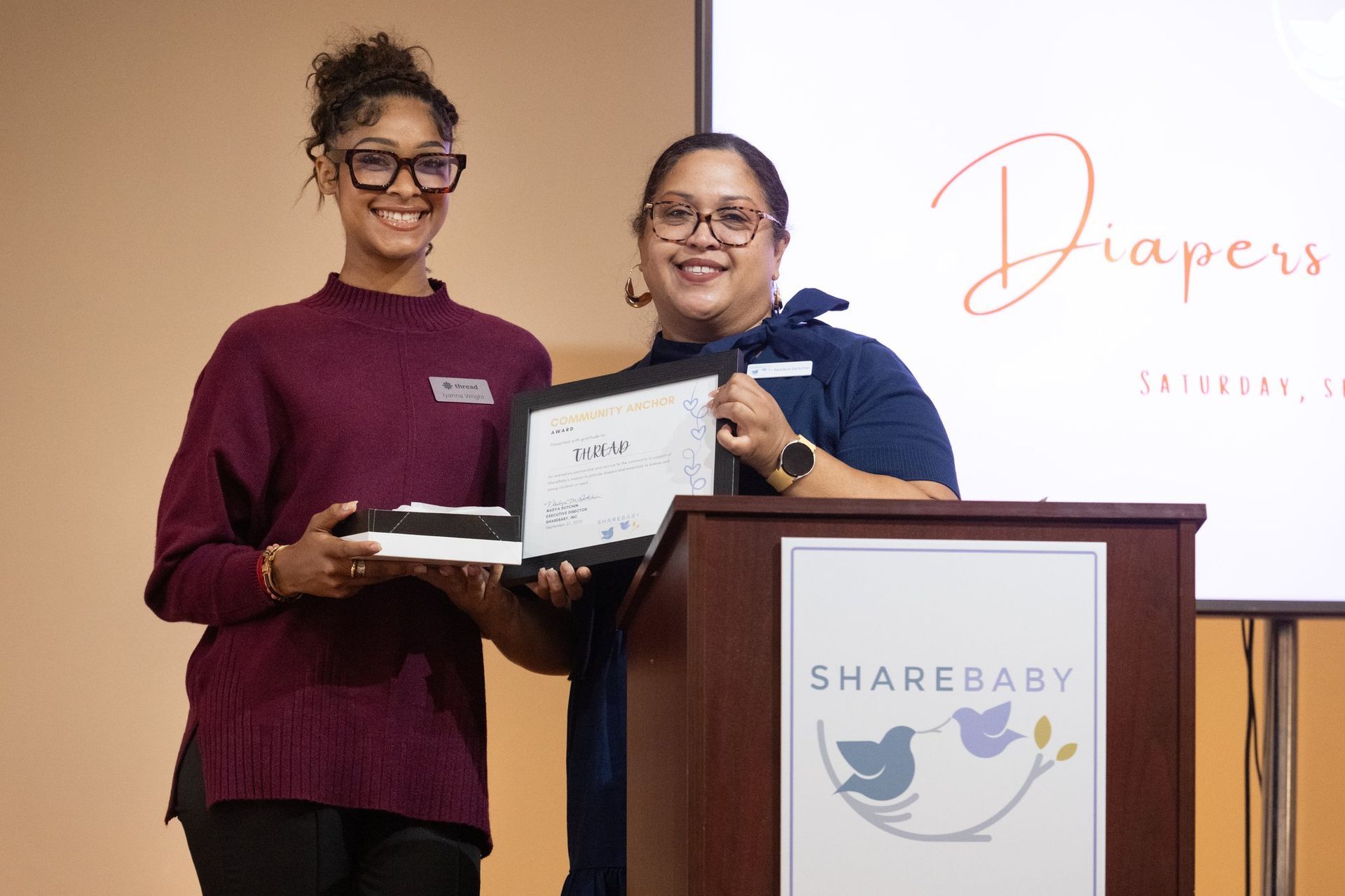 Sharebaby exec accepting a reward and diapers and donuts event