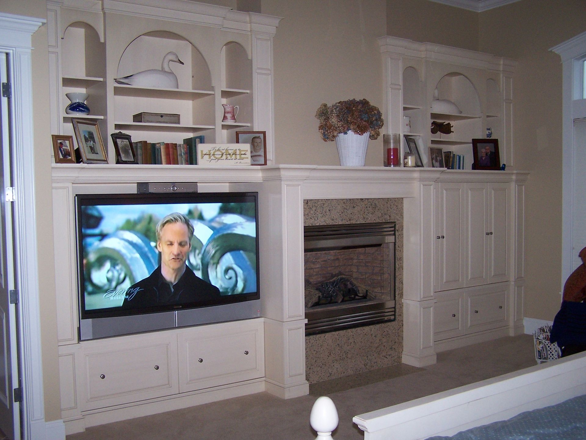 A living room with a fireplace and a flat screen tv