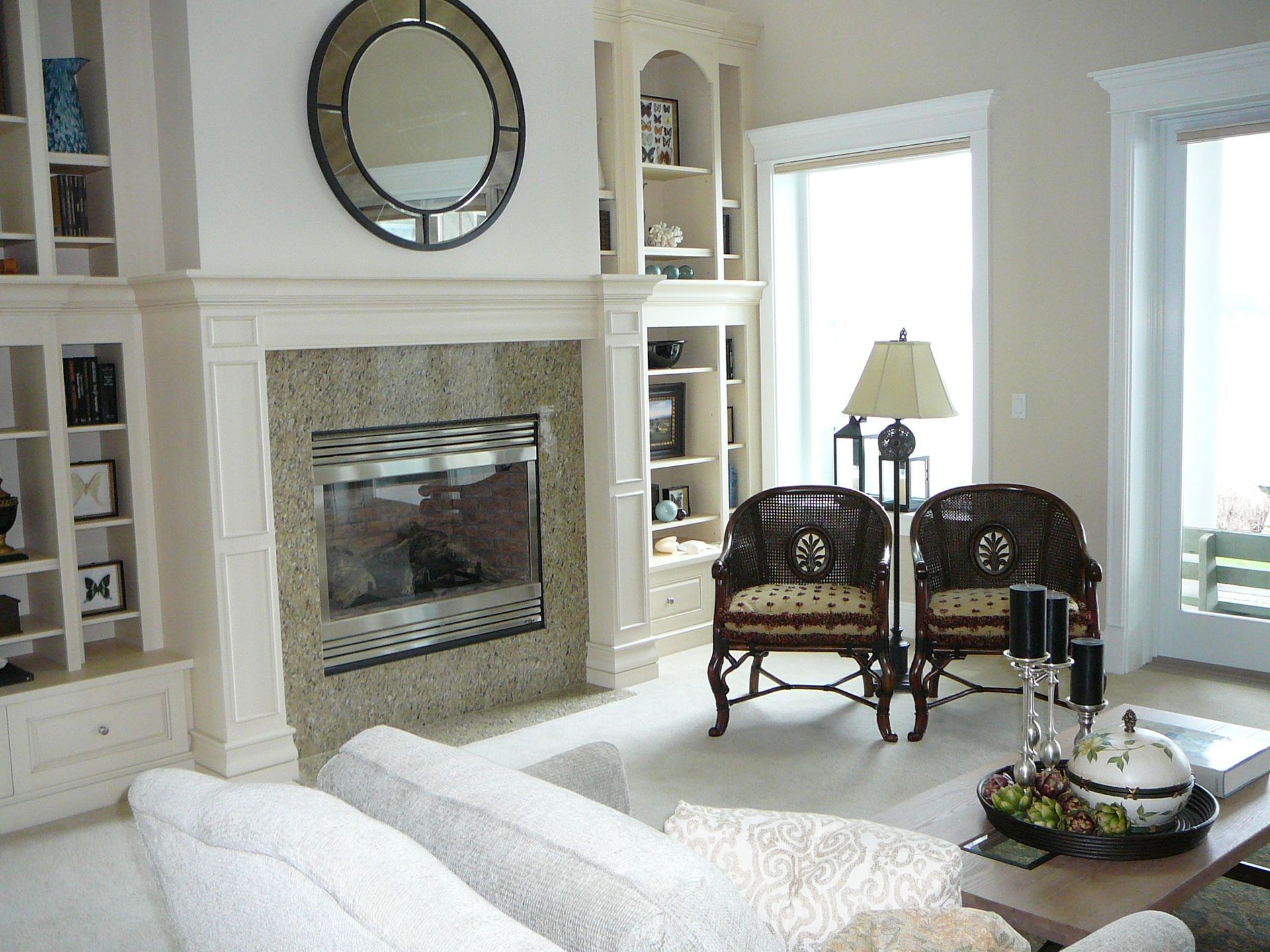 A living room with a fireplace couch and chairs