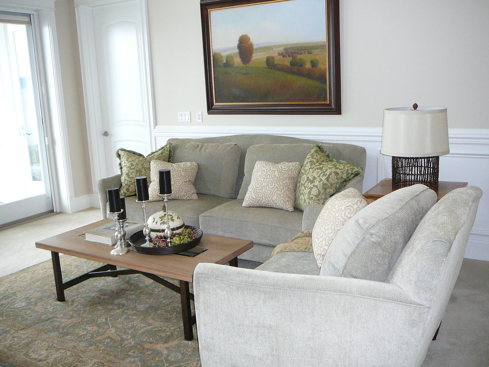 A living room with a couch and chairs and a coffee table