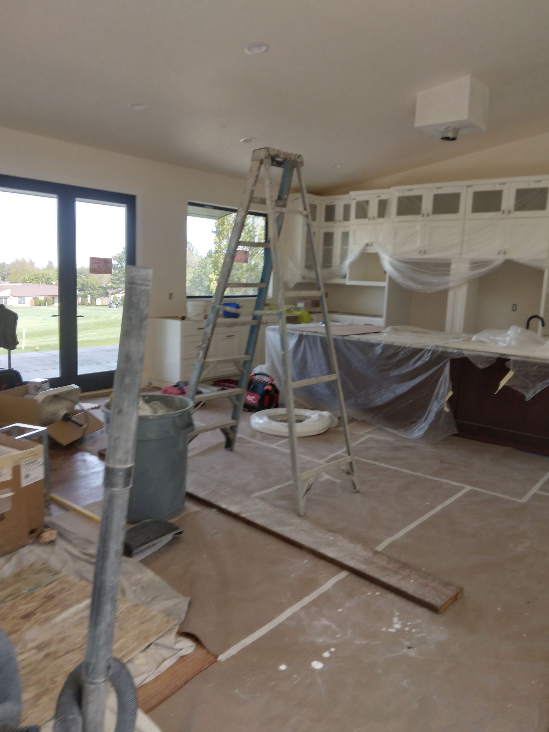A kitchen under construction with a ladder in the middle