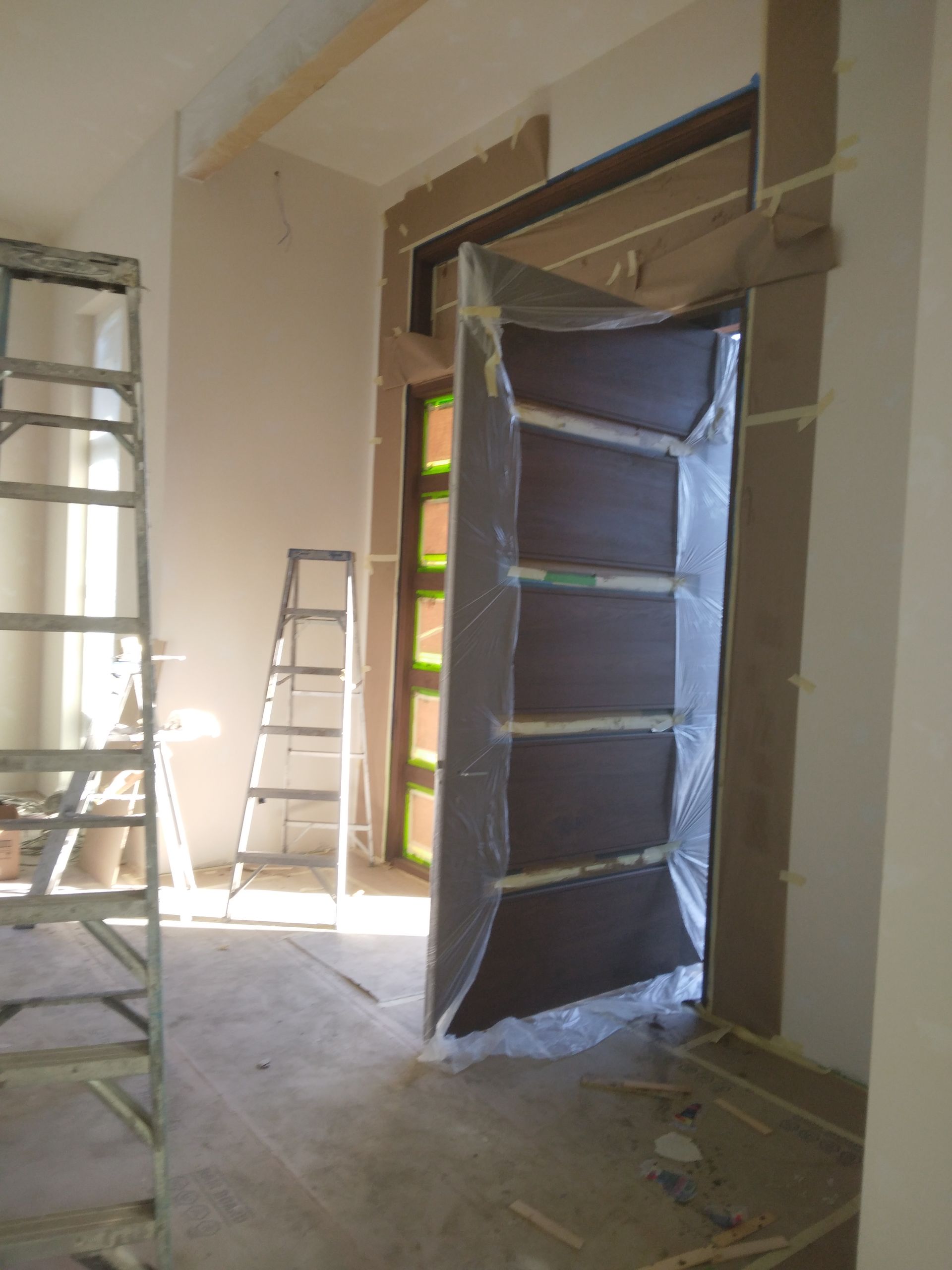 A room with a door and a ladder in it
