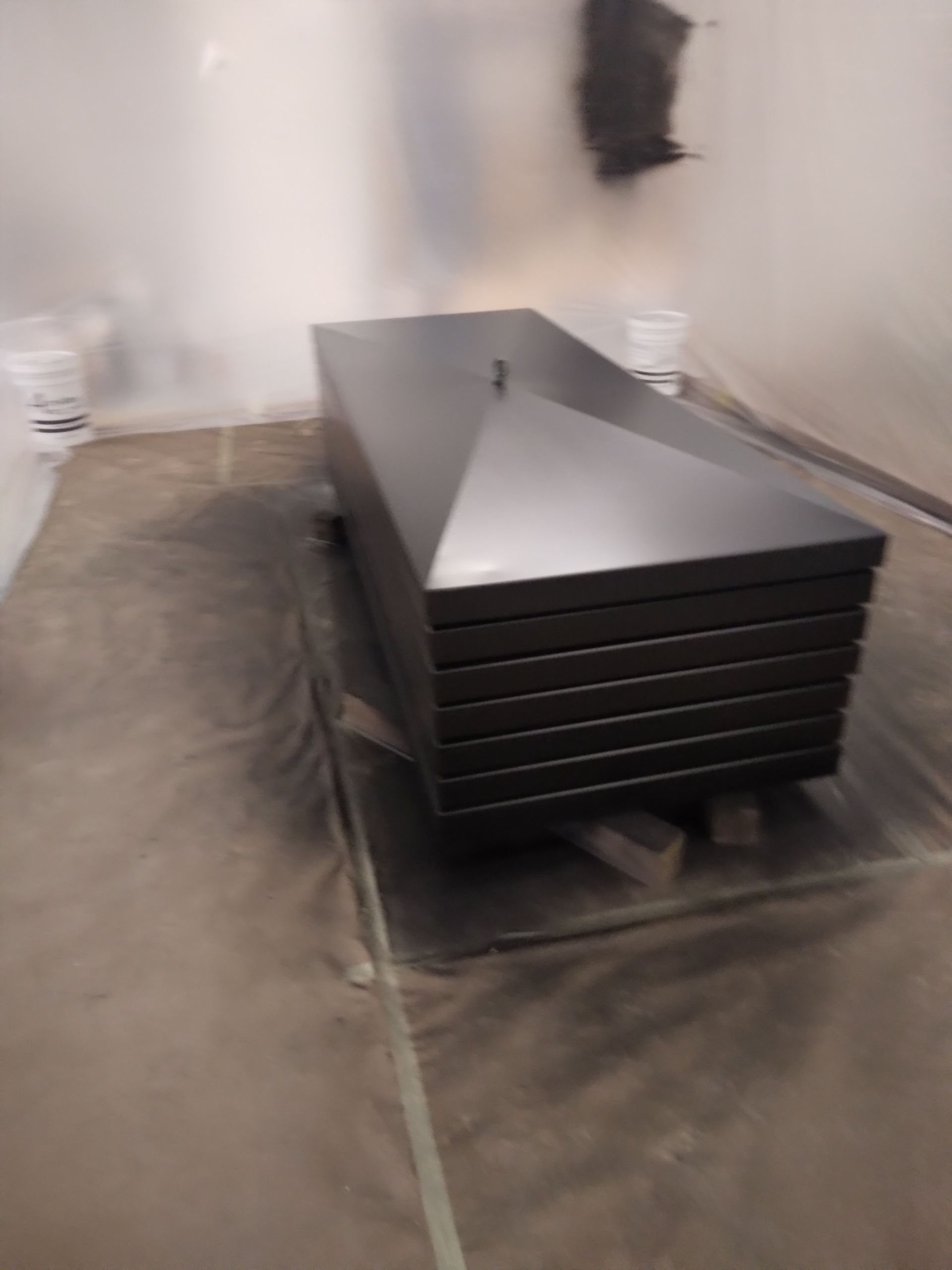 A black coffin is sitting on top of a table in a room.