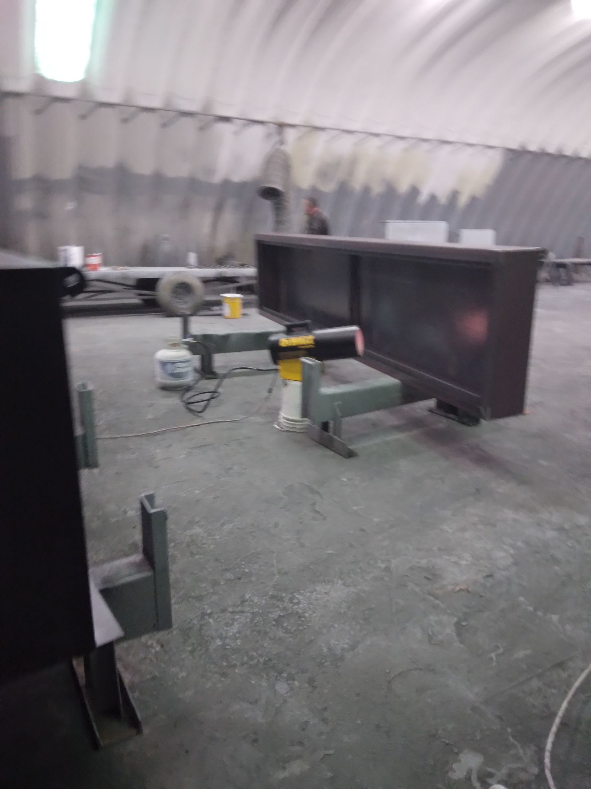 A warehouse with a lot of gray walls and a gray floor