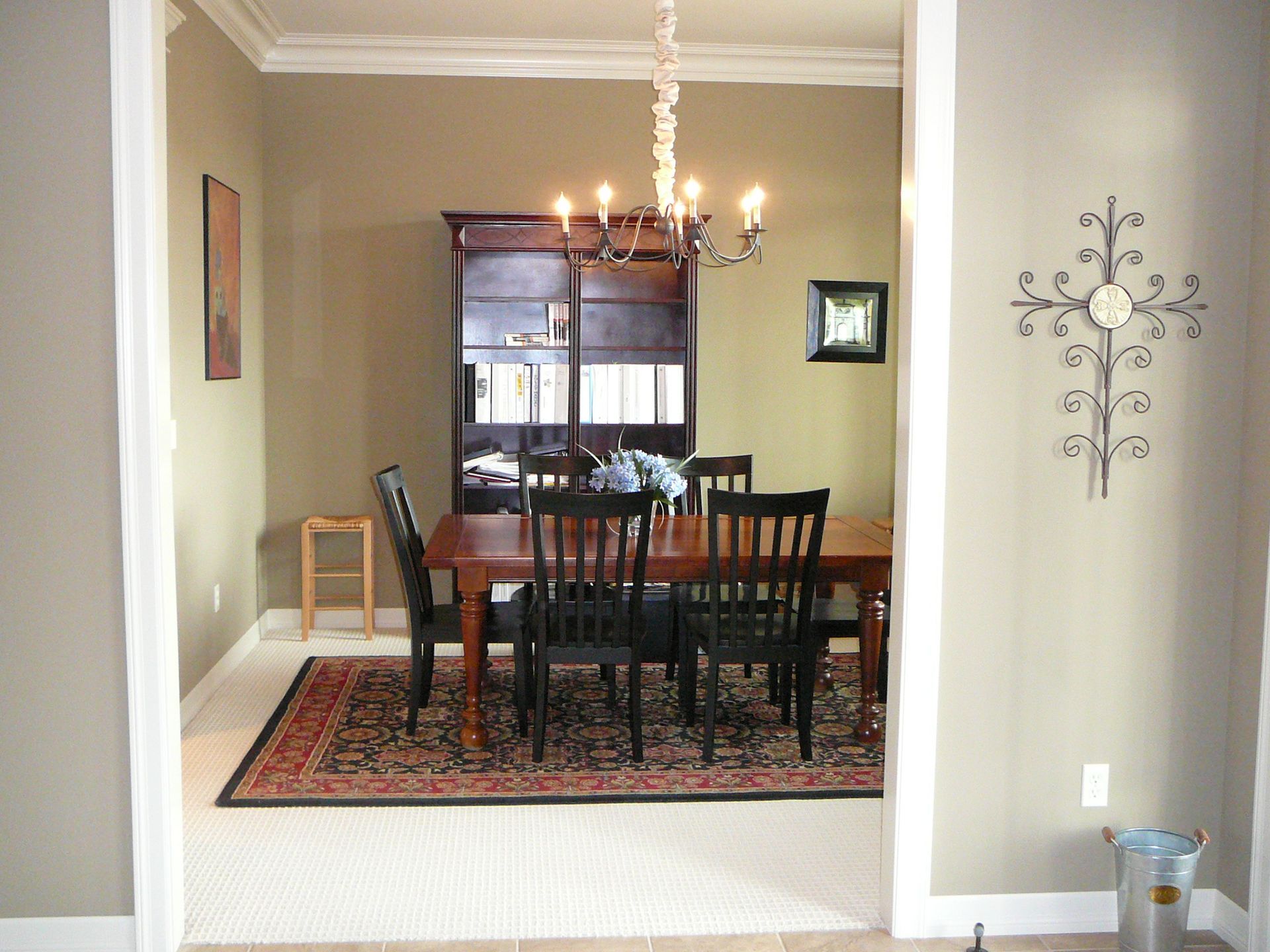A dining room with a table and chairs and a chandelier