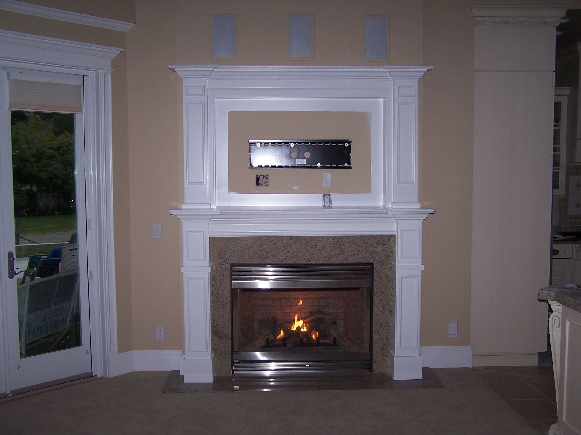 A fireplace with a flat screen tv mounted above it