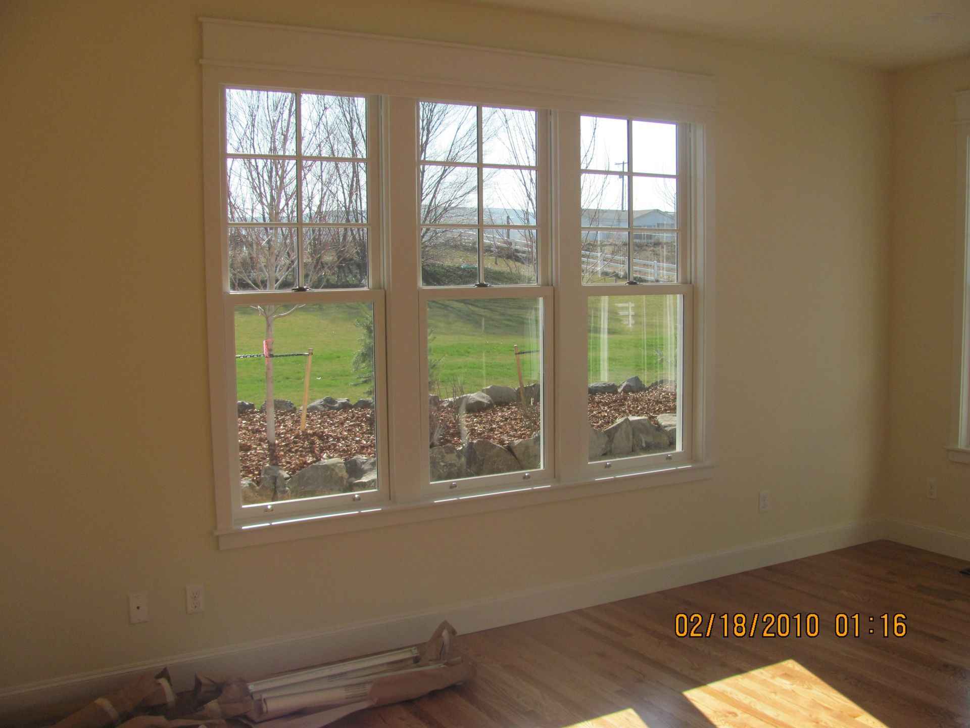 A room with three windows and a picture taken on february 18 2010