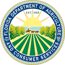 Florida Department of Agriculture and Consumer Services seal with sun, fields, and cattle