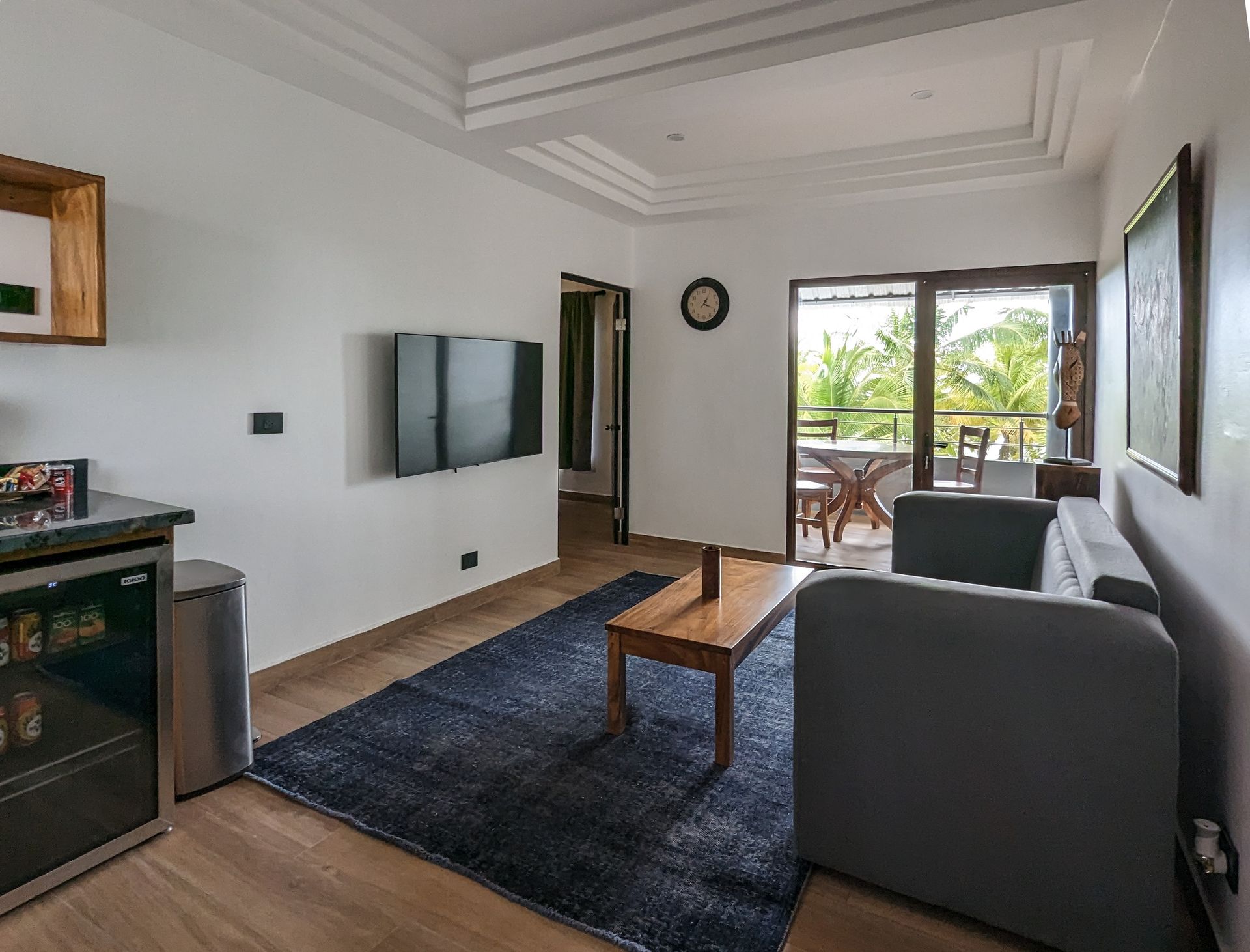 A living room with a couch , table , and television.