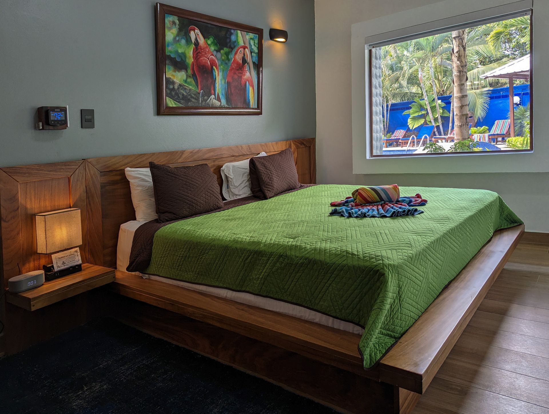 A bedroom with a large bed and a large window.