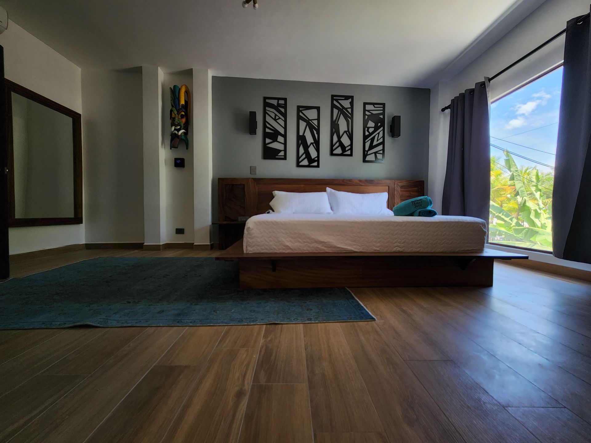 A bedroom with a large bed and a large window