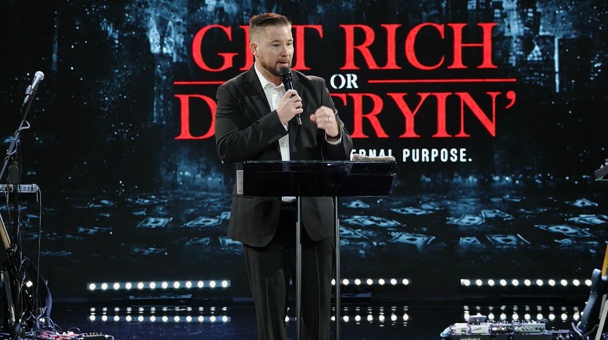 Chad Galbreath speaking from a podium on a large stage