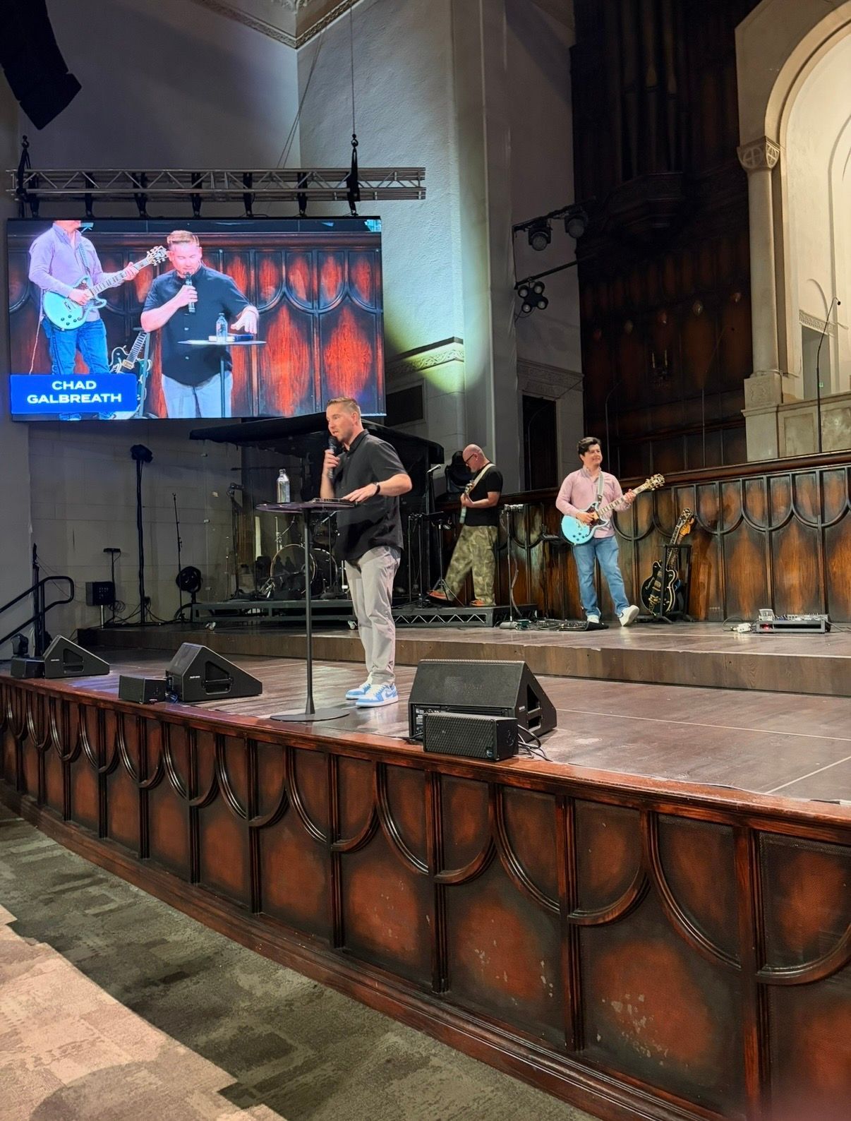 Chad Galbreath speaking from a platform in a church sanctuary