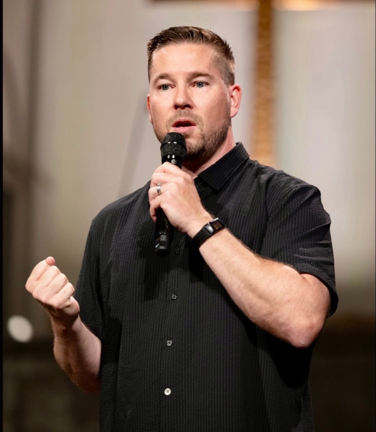 Chad Galbreath speaking into a microphone at a marriage event